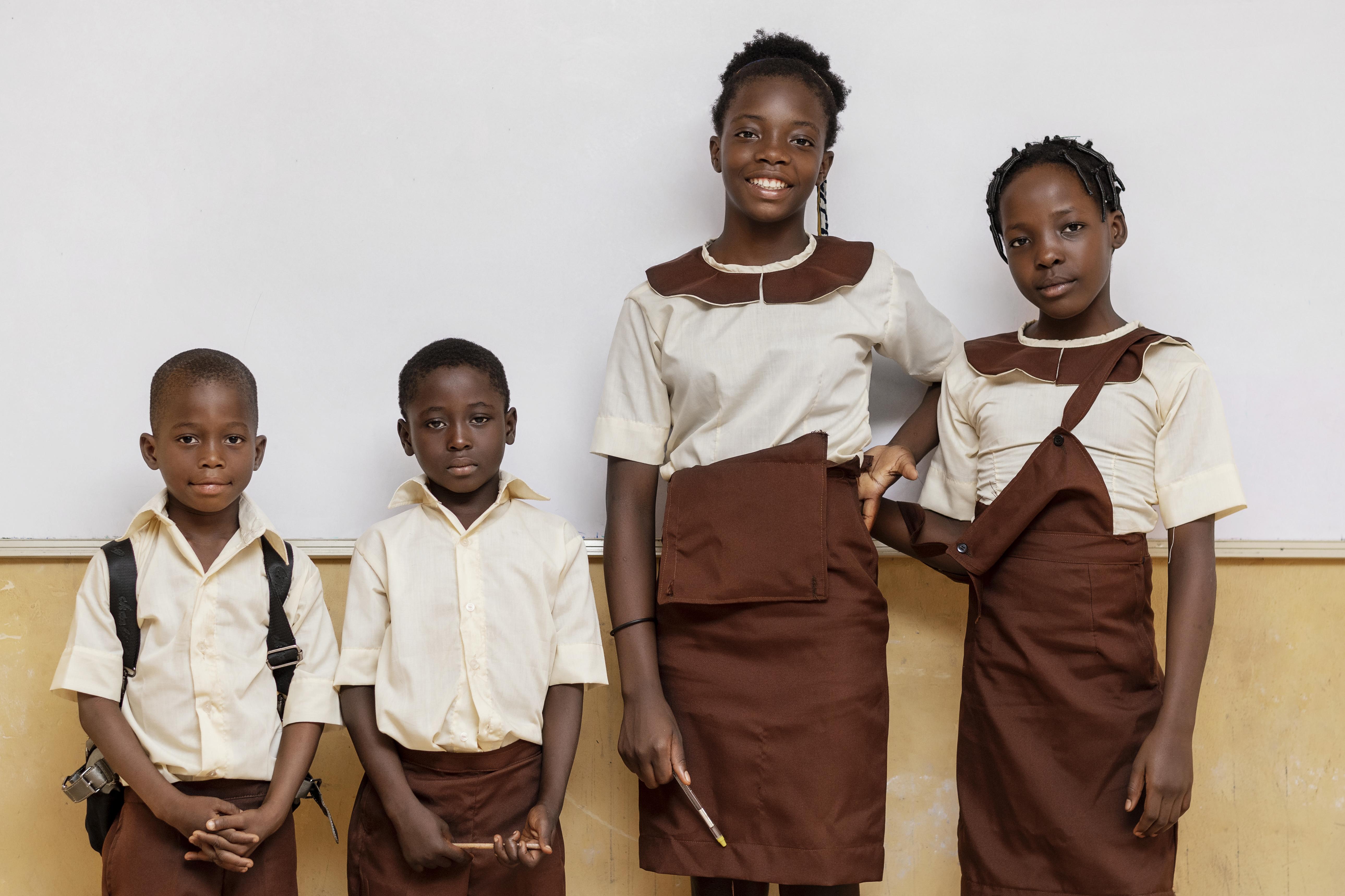 Children in classroom uniforms representing educational support